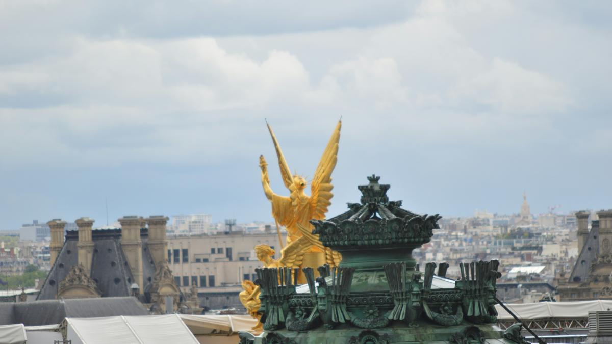 a view of a building with a golden statue on top of it