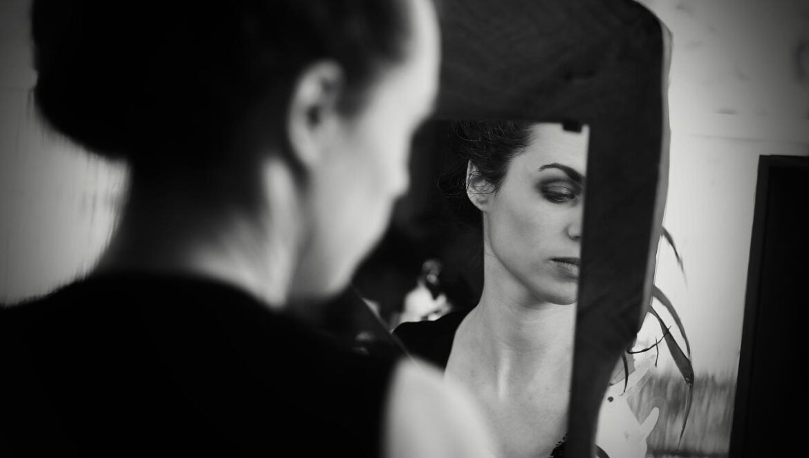 a woman looking at herself in the mirror
