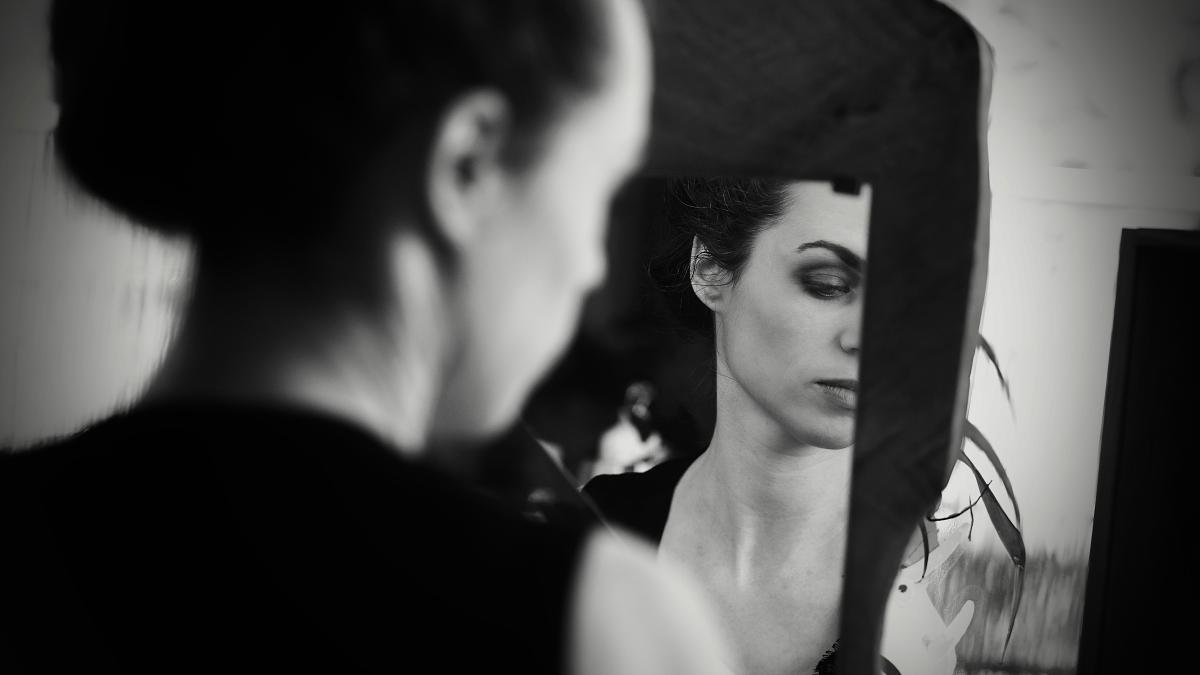 a woman looking at herself in the mirror