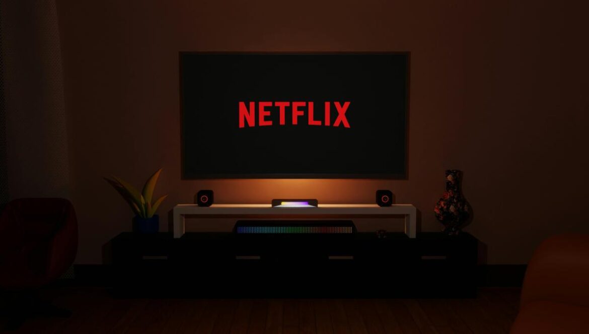 a dark room with a television and a neon netflix sign
