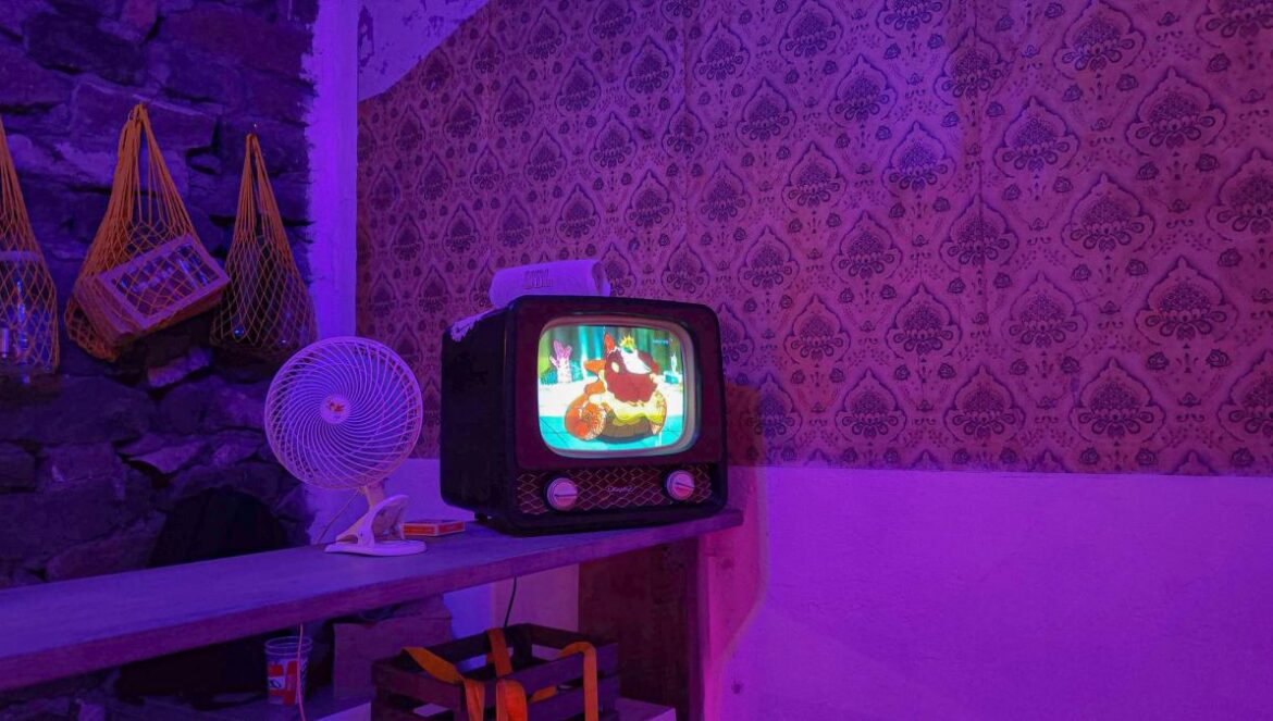 A small TV sitting on top of a wooden table