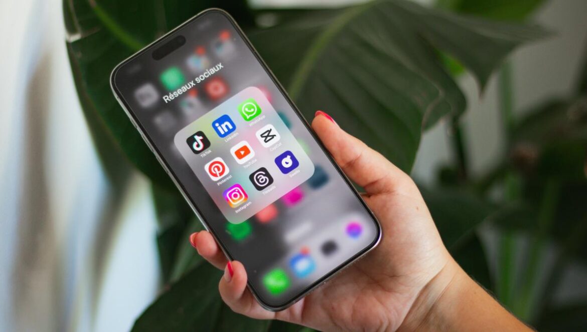 A person holding a cell phone in their hand