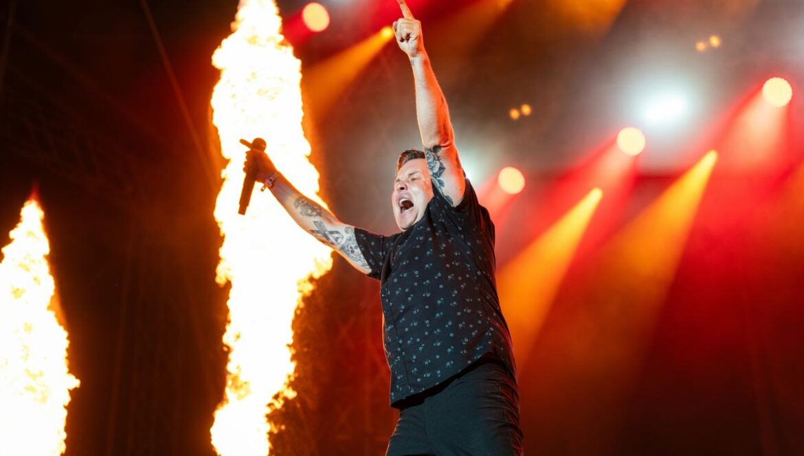 A man standing on top of a stage holding a microphone