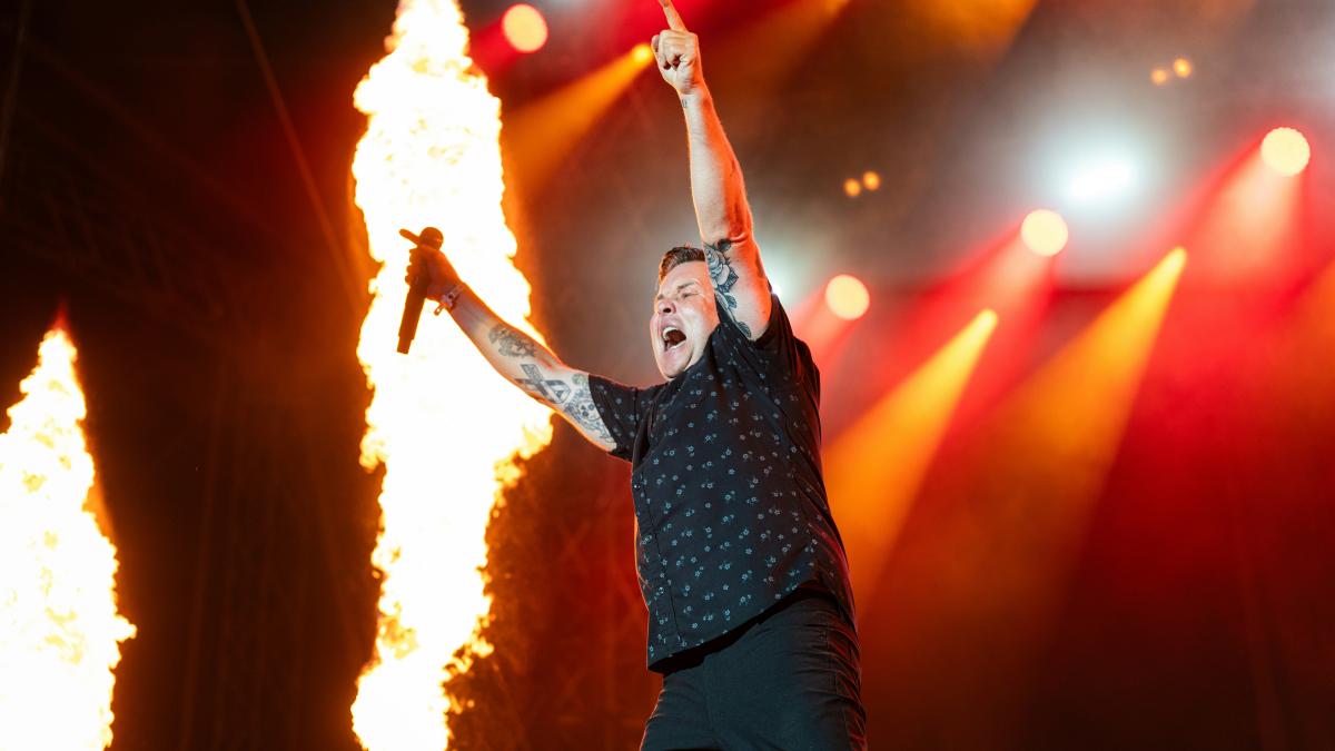 A man standing on top of a stage holding a microphone