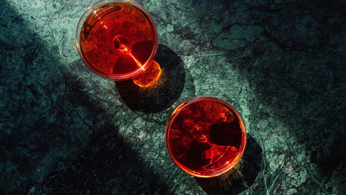 Two red cups sitting next to each other on a table