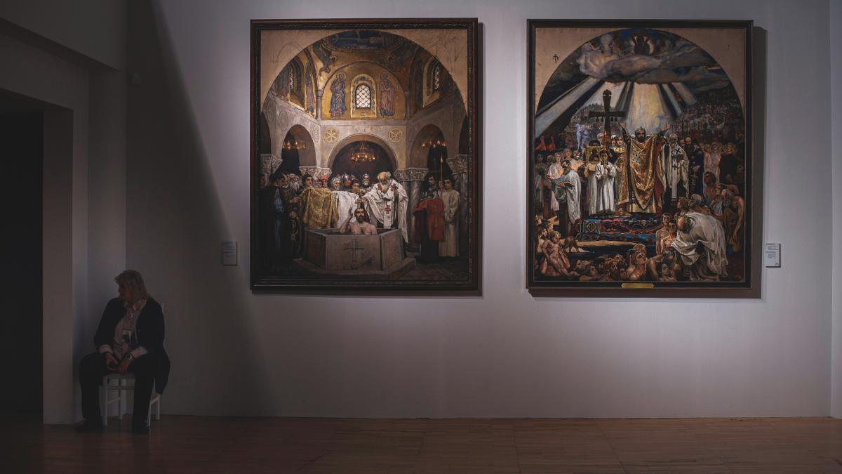 A couple of paintings hanging on a wall