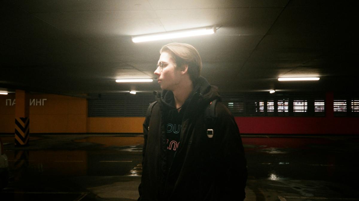 A woman standing in a parking garage next to a fire hydrant