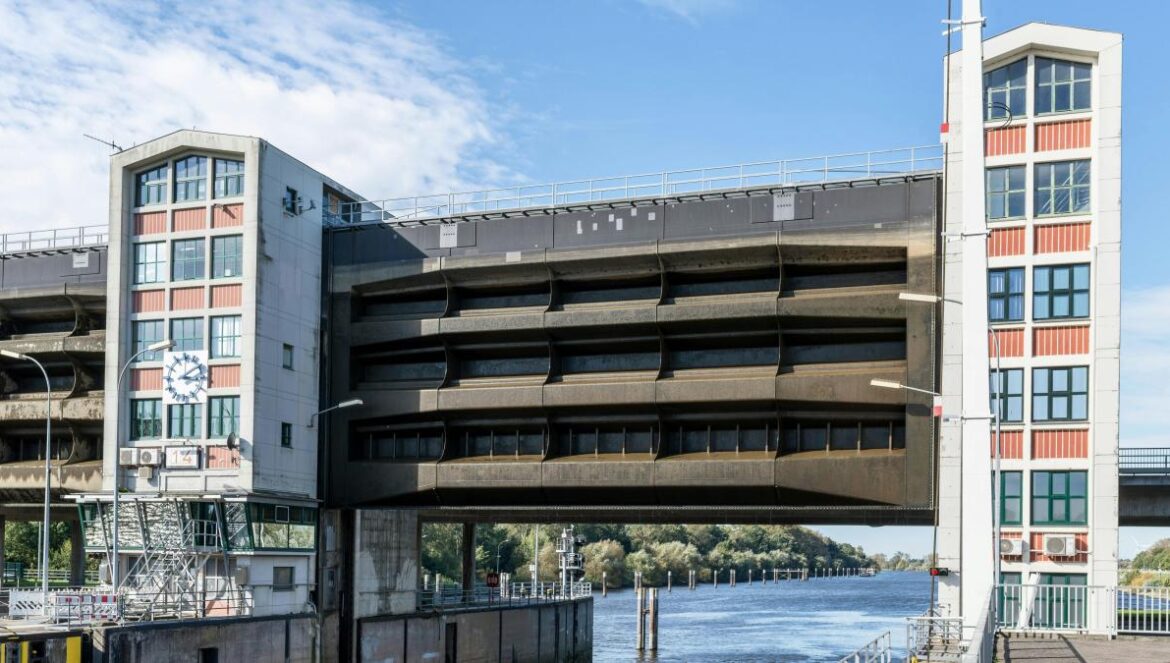A bridge over a body of water with a building in the background