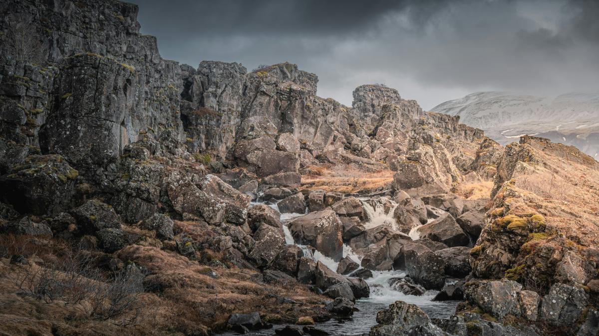 A river running through a rocky landscape under a cloudy sky