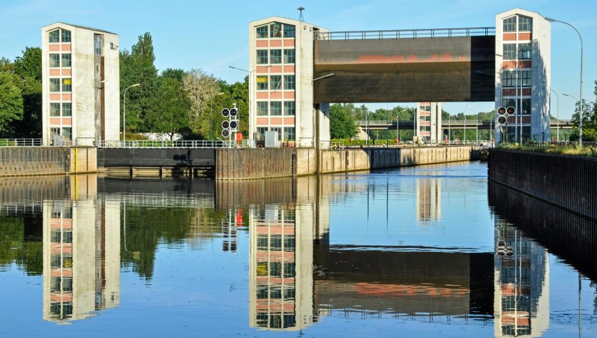 A body of water with a bridge in the background