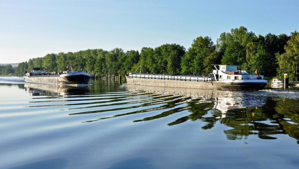 A couple of boats floating on top of a lake
