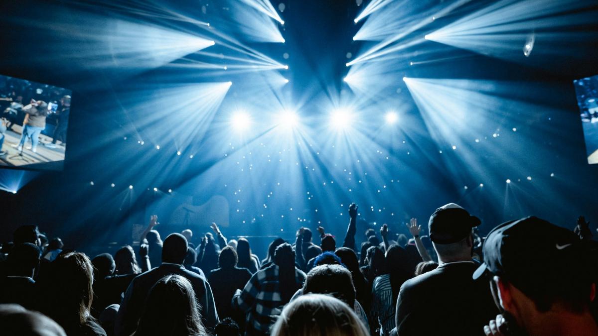 A large crowd of people in a dark room