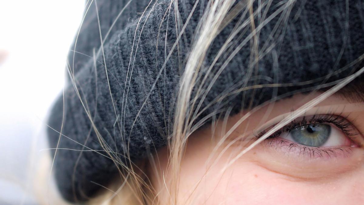 A close up of a person wearing a hat