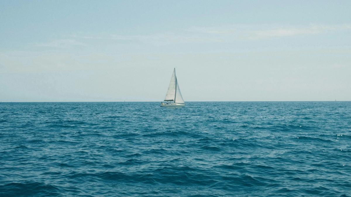 A sailboat in the middle of the ocean