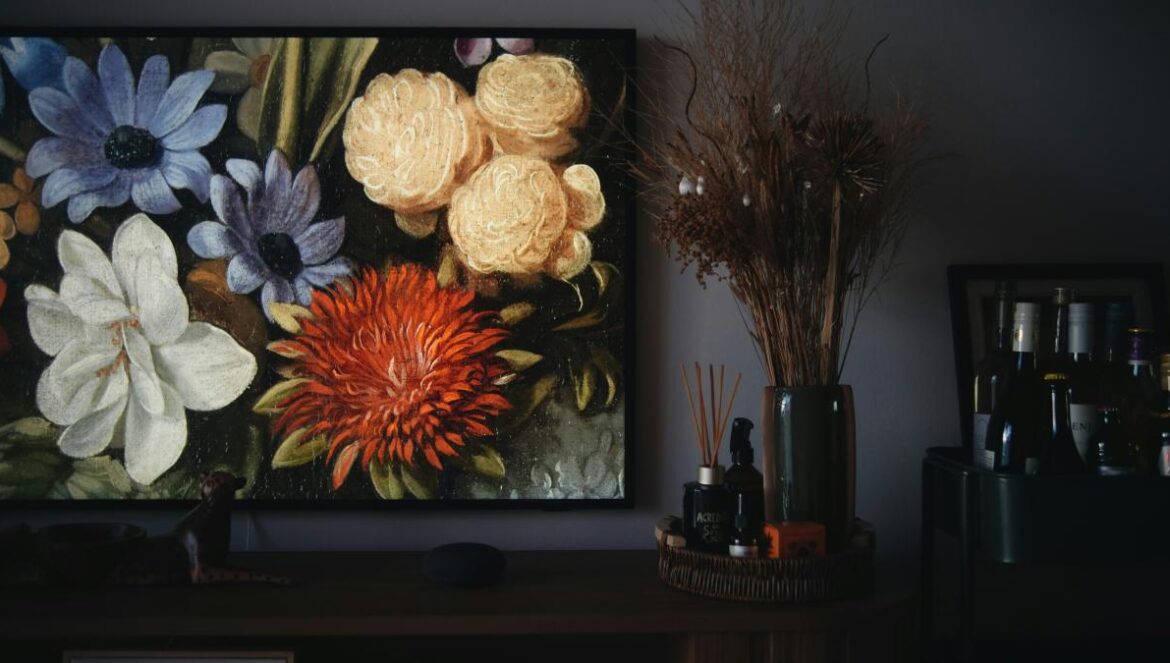 A painting of flowers on a wall in a living room