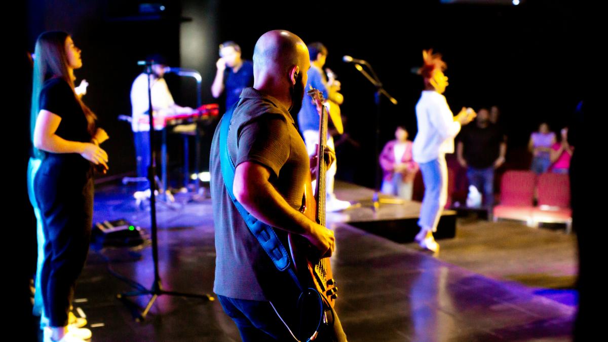 A group of people that are standing on a stage