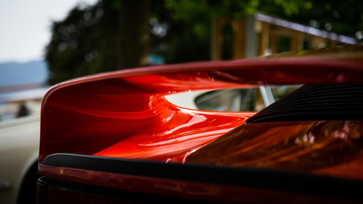 A close up of the hood of a red car