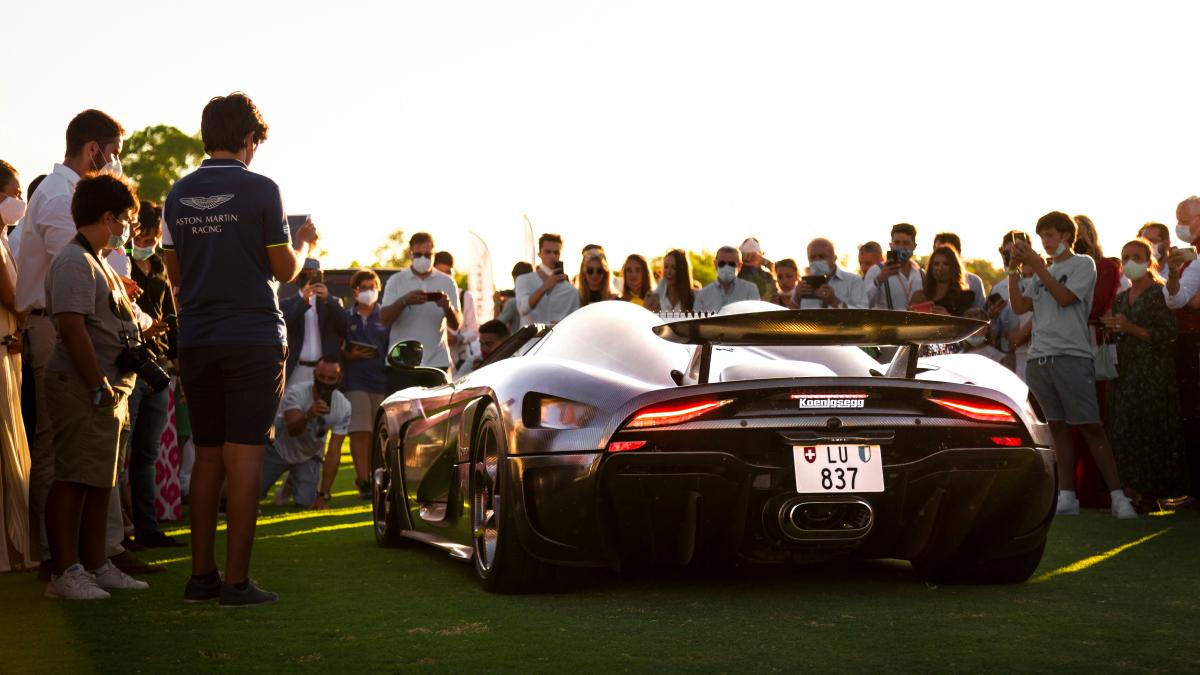 A sports car parked in front of a crowd of people