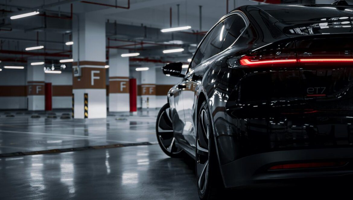 A black car parked in a parking garage