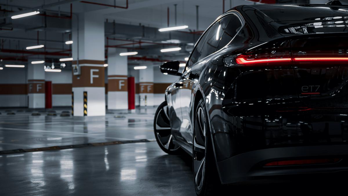 A black car parked in a parking garage