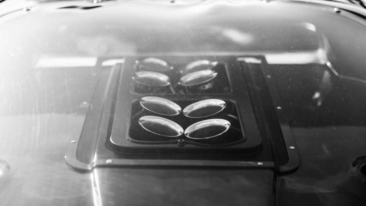 Close-up of a car hood with four vents.