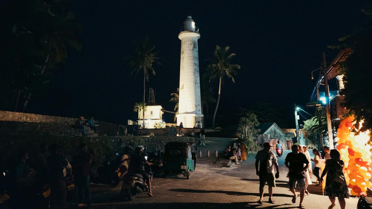 A lighthouse stands tall at night.