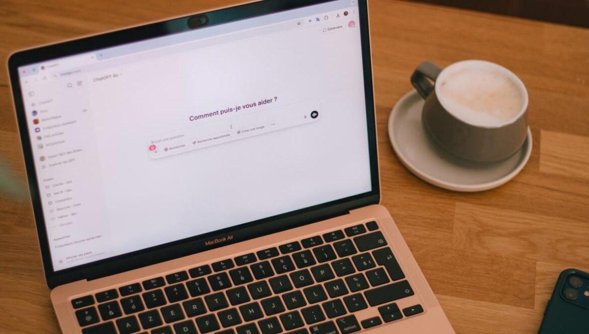Laptop and coffee on a wooden table.
