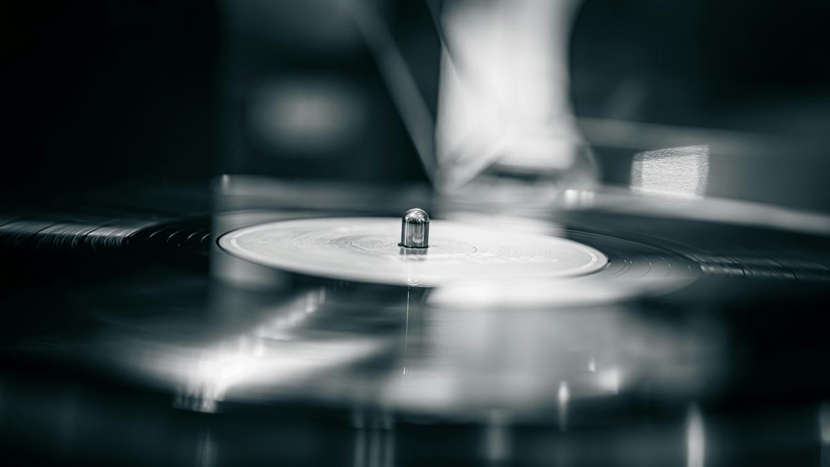 A record player with its needle engaged.