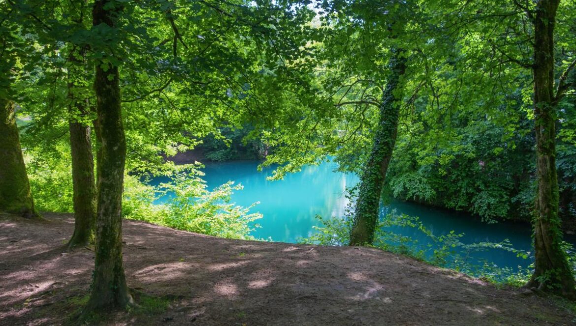A scenic view of a turquoise lake.