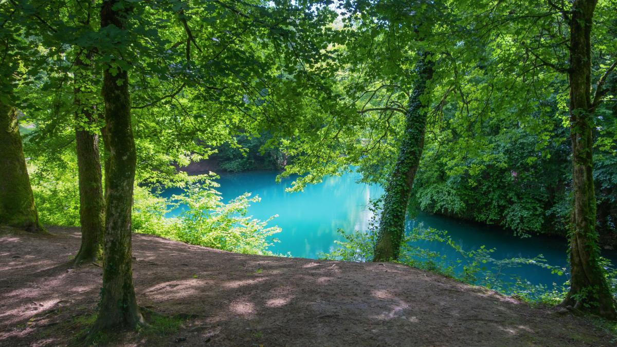 A scenic view of a turquoise lake.