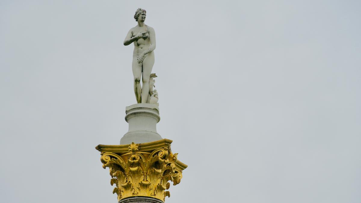 a statue of a man on top of a building
