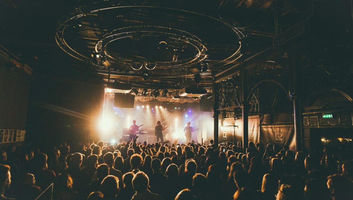 people attending concert inside dark room