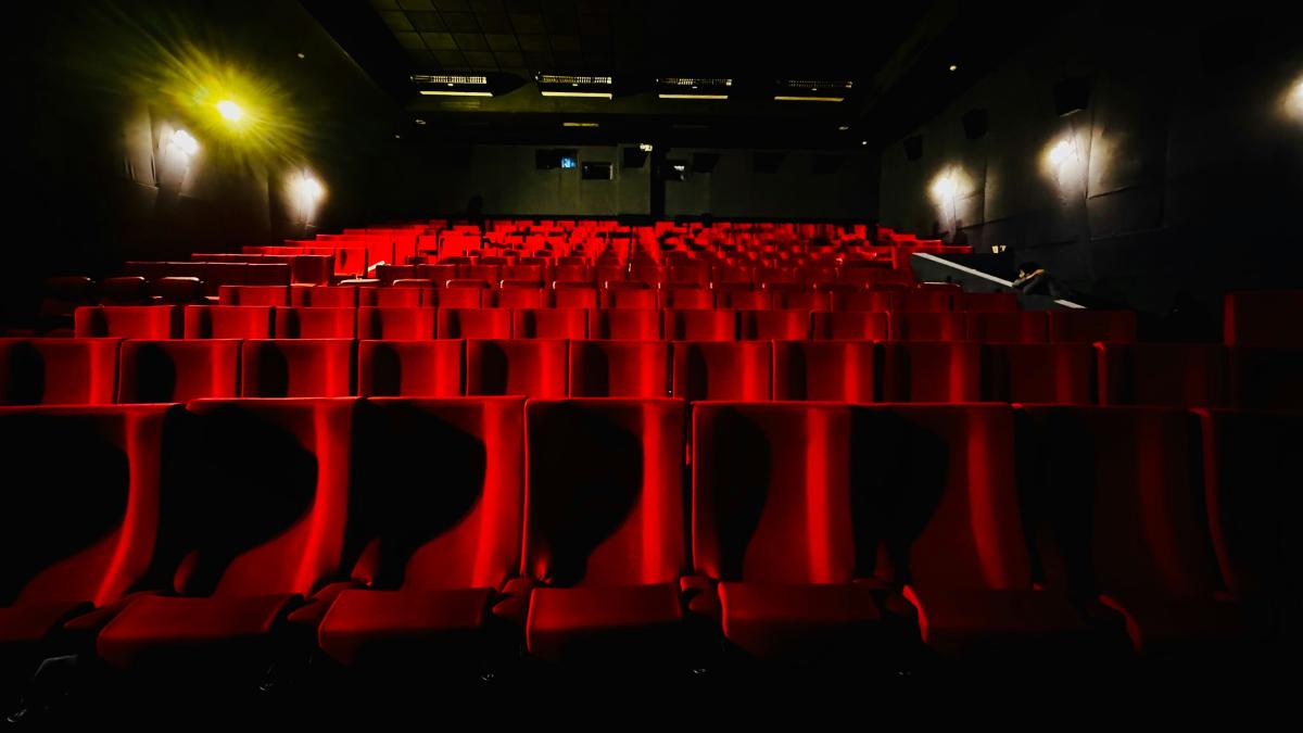 Empty movie theater seats await the audience.