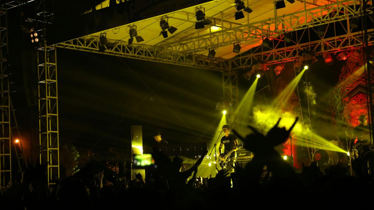 a crowd of people standing on top of a stage
