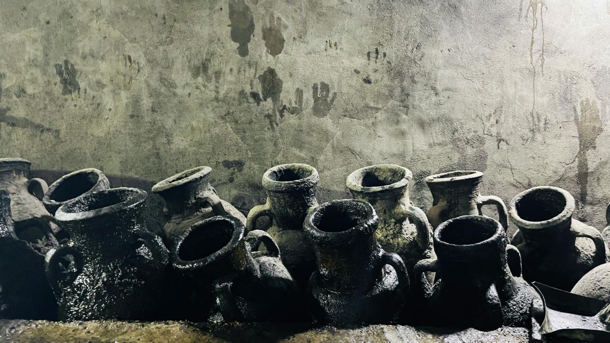 a group of vases sitting on top of a cement floor