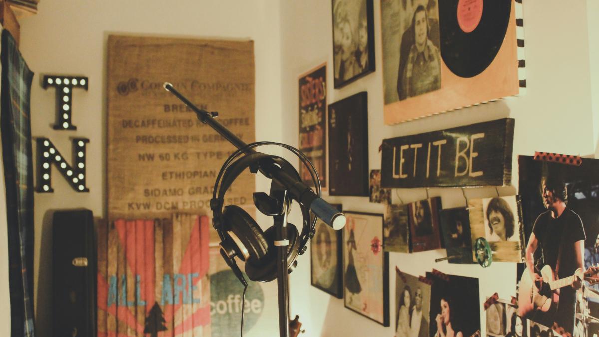 black condenser mic with stand and headphones