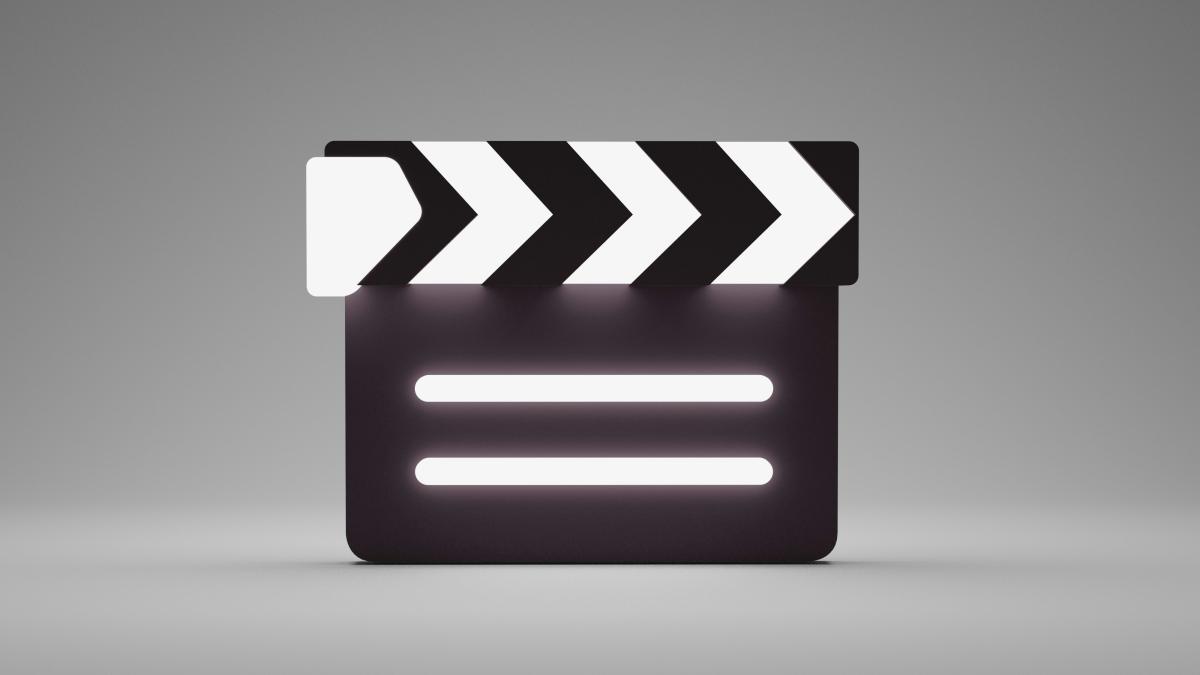 a black and white movie clapper on a gray background