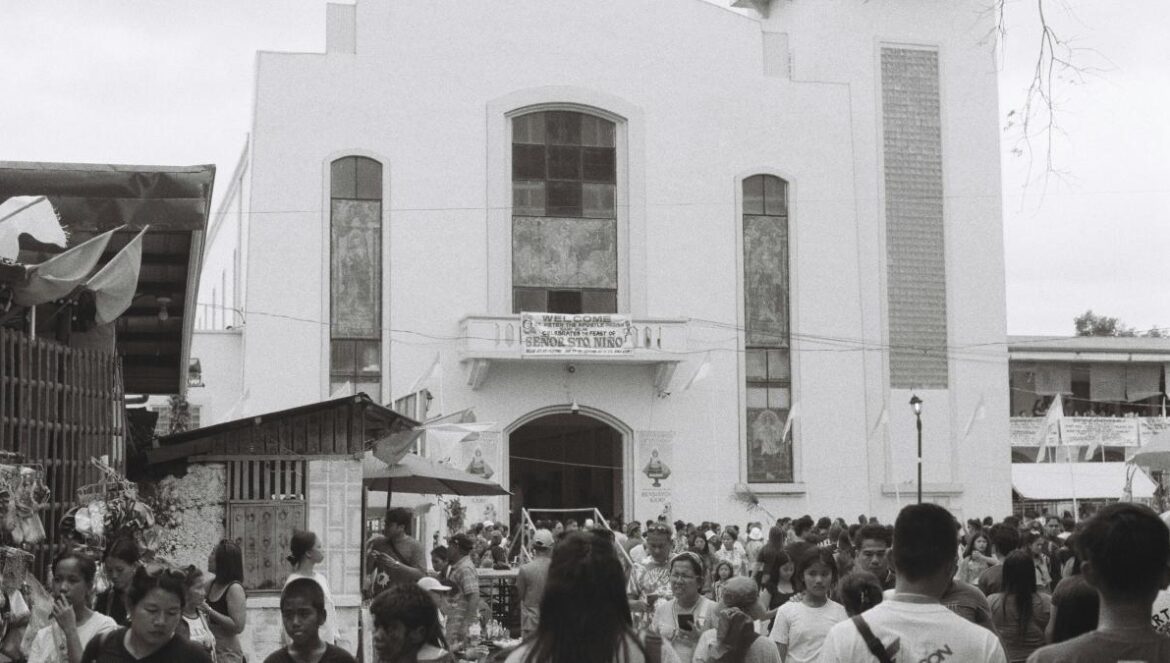 A crowd of people standing in front of a church