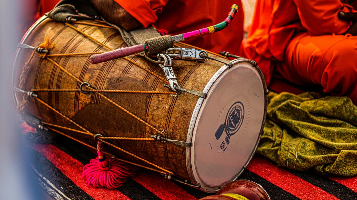 a group of people sitting around a drum