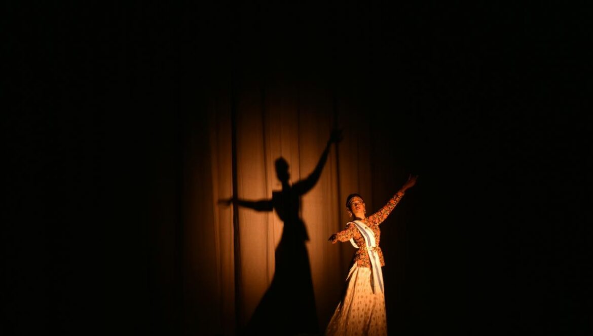 woman in white dress dancing on stage