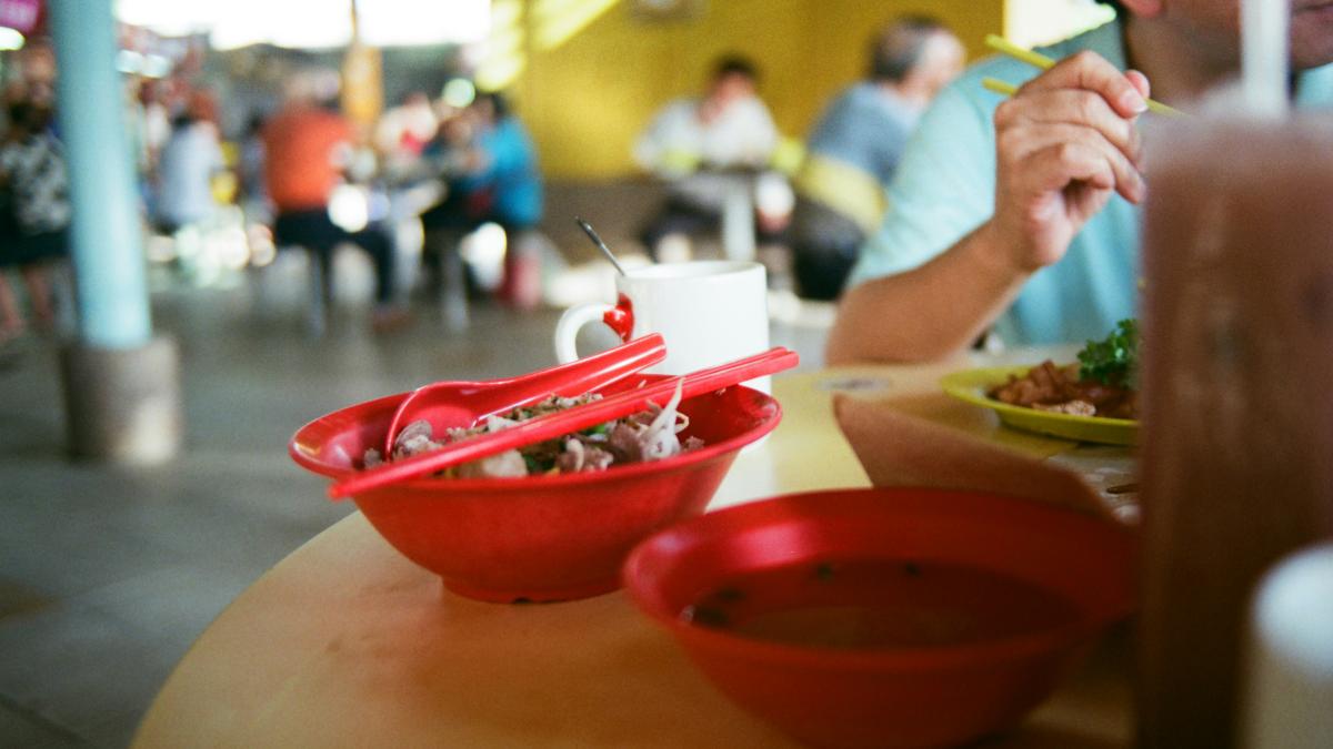 a man sitting at a table with a plate of food