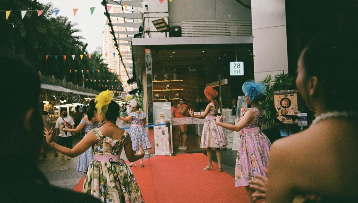 a group of women standing on top of a red carpet