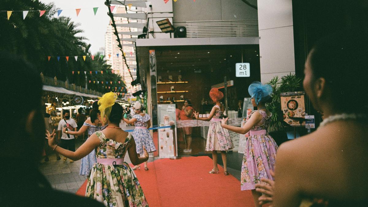 a group of women standing on top of a red carpet