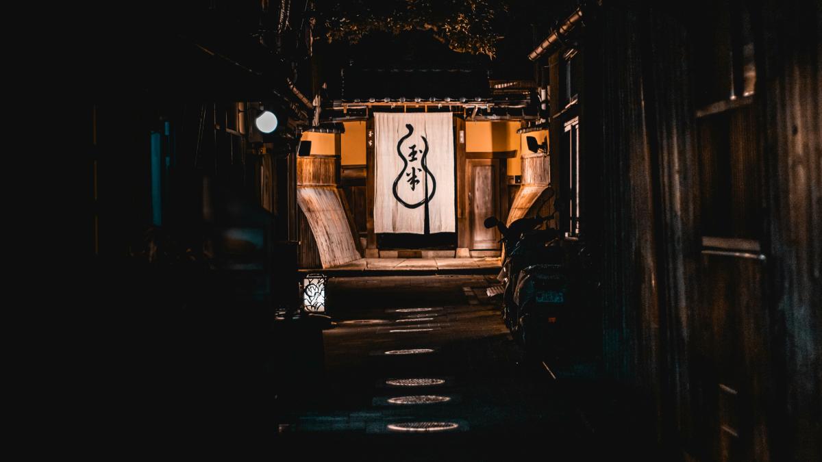 pathway to lighted brown house