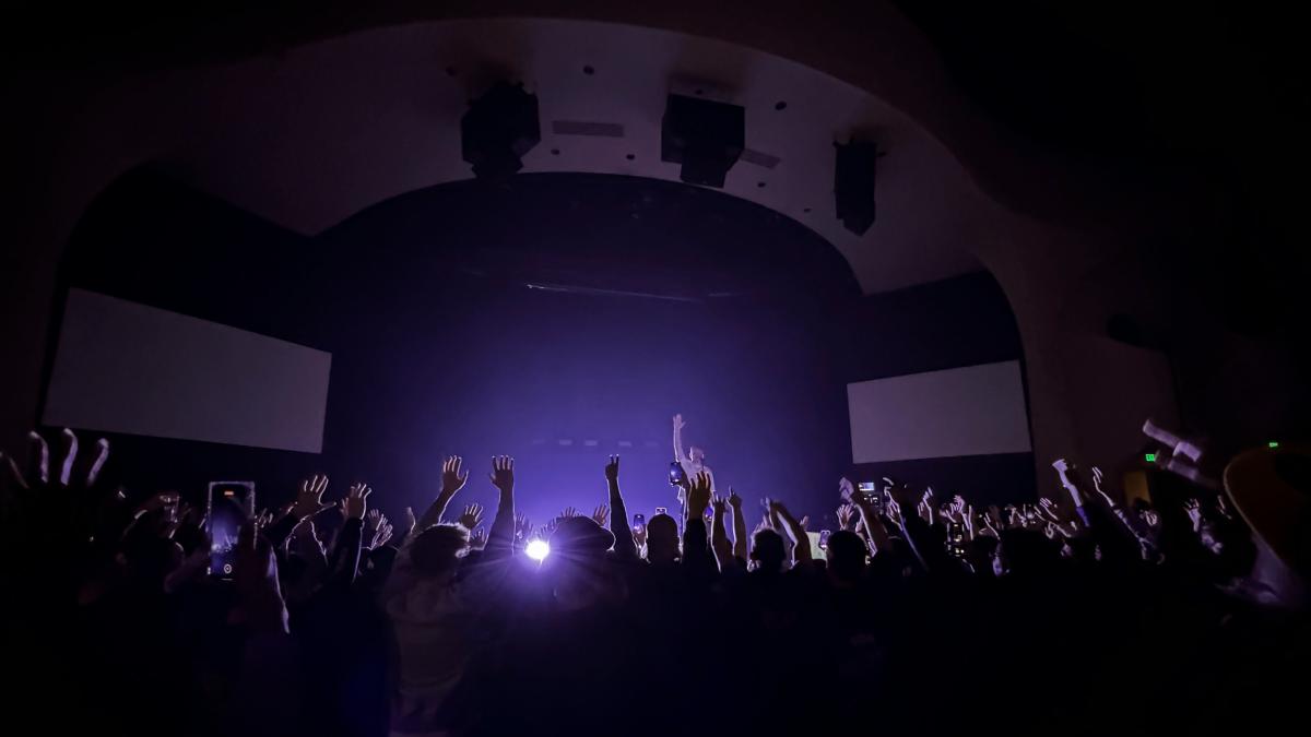 A crowd cheers during a concert.