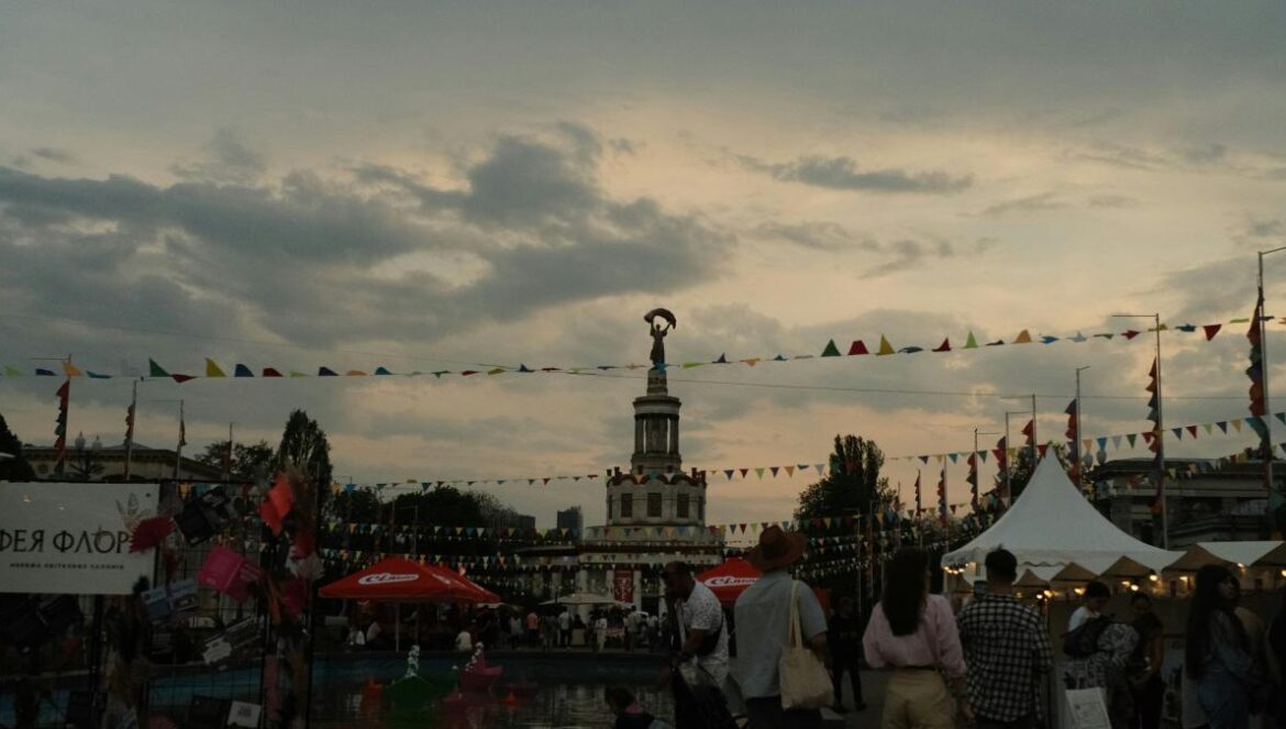 A fair or festival is happening outdoors at dusk.
