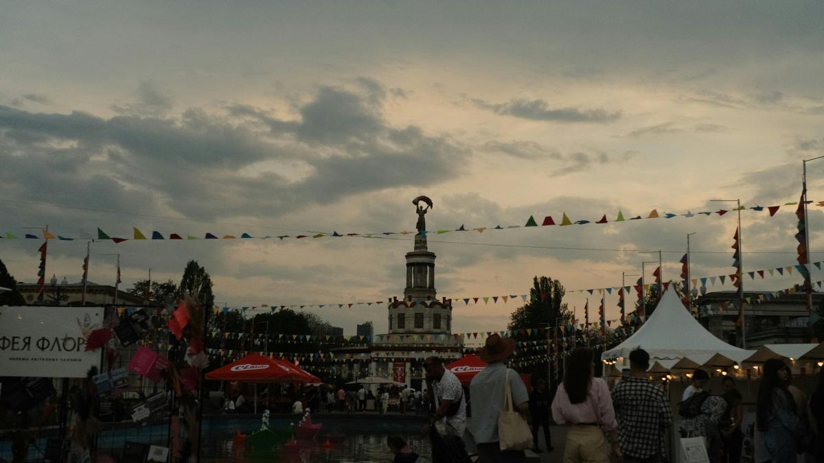 A fair or festival is happening outdoors at dusk.