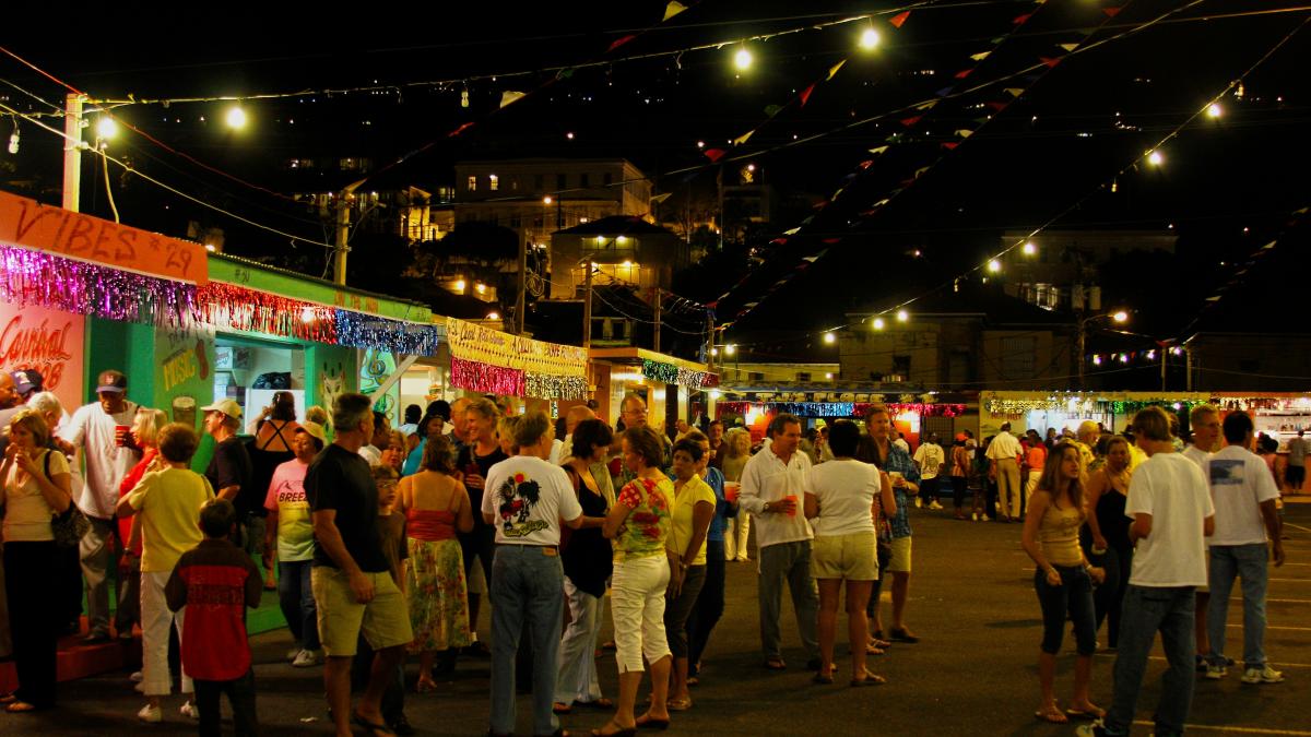 a crowd of people standing around a food truck