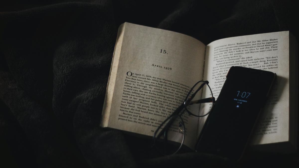 black smartphone on book