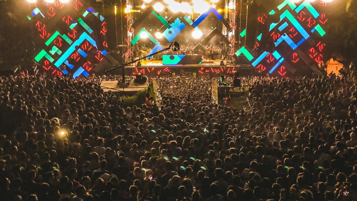 crowd of people watching concert during night time